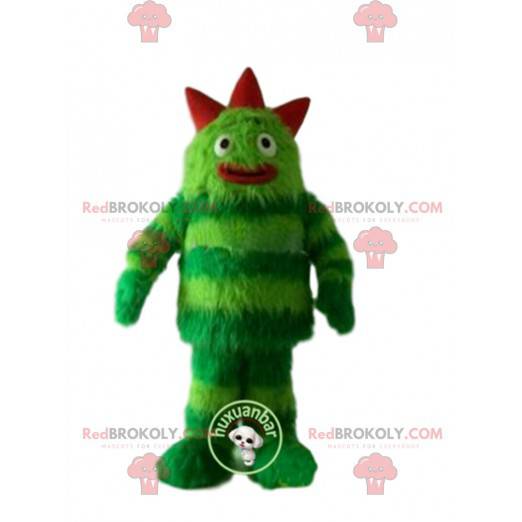 Groen monster mascotte, harig en onderhoudend. Groen pak -