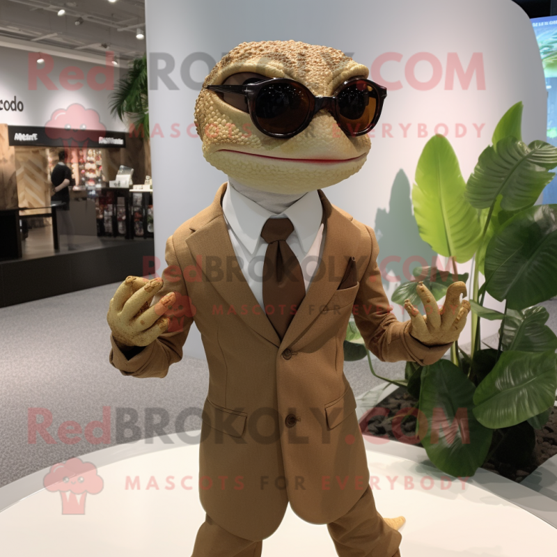 Tan Geckos mascot costume character dressed with a Suit and Eyeglasses