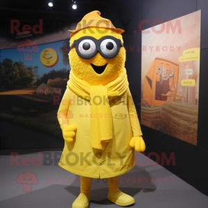 Yellow Momentum mascot costume character dressed with a Button-Up Shirt and Shawl pins