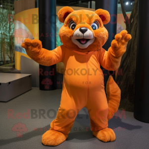 Orange Jaguarundi mascot costume character dressed with a Culottes and Foot pads