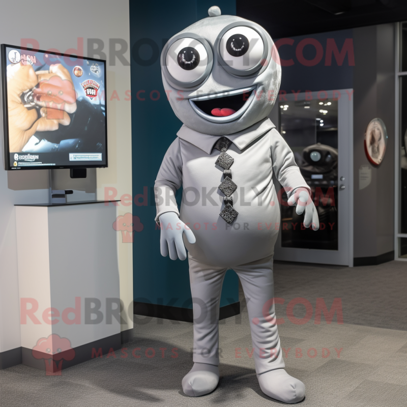 Silver Cyclops mascot costume character dressed with a Button-Up Shirt and Tie pins