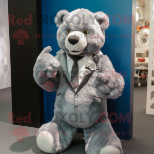 Silver Teddy Bear mascot costume character dressed with a Suit Jacket and Rings