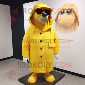 Yellow Walrus mascot costume character dressed with a Raincoat and Sunglasses