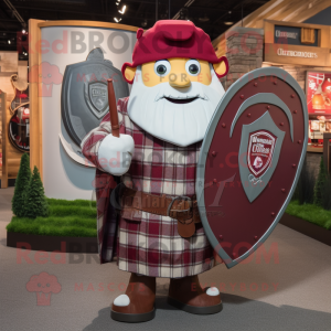 Maroon Celtic Shield mascot costume character dressed with a Flannel Shirt and Hat pins