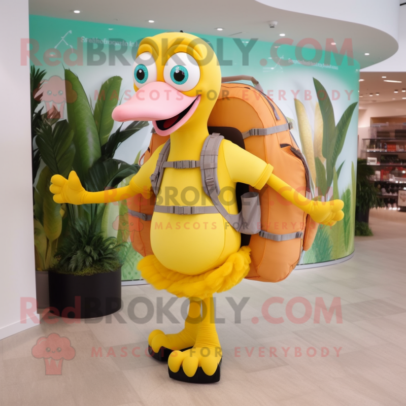 Yellow Flamingo mascot costume character dressed with a Capri Pants and Backpacks