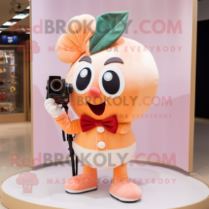 Peach Camera mascot costume character dressed with a Shorts and Bow ties