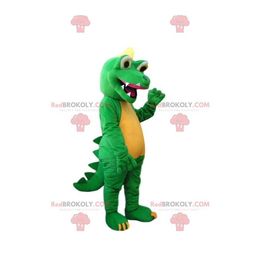 Groene en gele dinosaurusmascotte met een enorme glimlach -