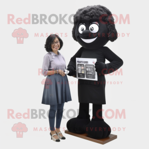 Black Candy Box mascot costume character dressed with a Mom Jeans and Reading glasses