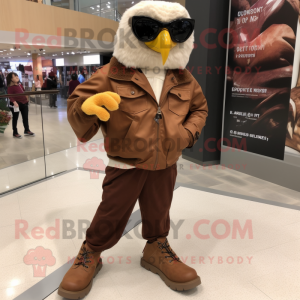 Brown Falcon mascot costume character dressed with a Leather Jacket and Shoe clips