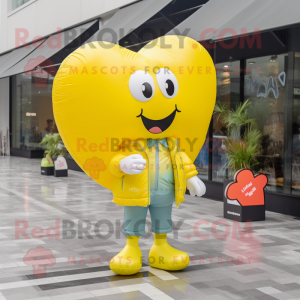 Lemon Yellow Heart Shaped Balloons mascot costume character dressed with a Windbreaker and Tote bags