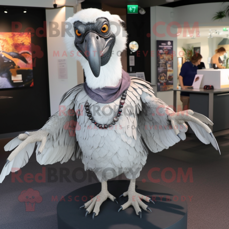 Silver Vulture mascot costume character dressed with a Button-Up Shirt and Shawl pins