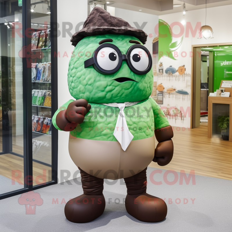 Green Chocolates mascot costume character dressed with a Dress Pants and Eyeglasses