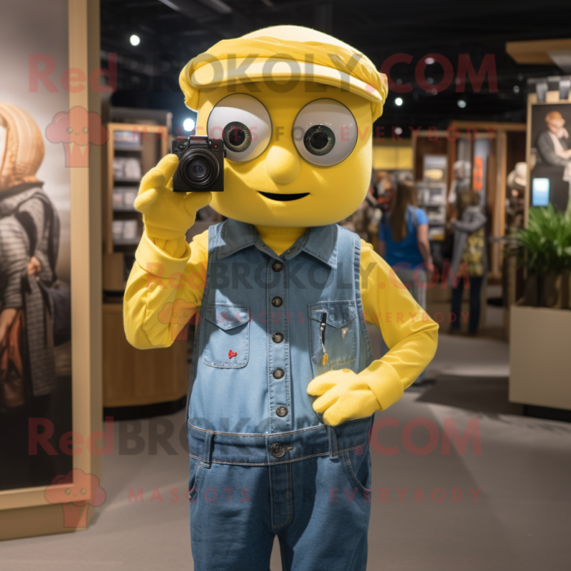 Yellow Camera mascot costume character dressed with a Chambray Shirt and Earrings