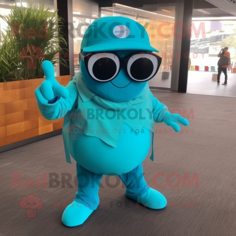 Turquoise Cod mascot costume character dressed with a Overalls and Sunglasses