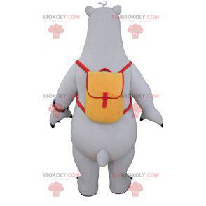 Mascote urso cinza e branco com uma mochila escolar -