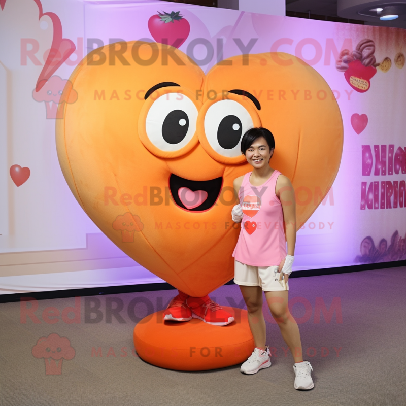 Peach Heart mascot costume character dressed with a Tank Top and Shoe clips