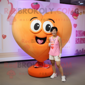 Peach Heart mascot costume character dressed with a Tank Top and Shoe clips