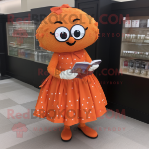 Orange Meatballs mascot costume character dressed with a Dress and Reading glasses