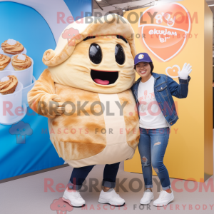 Mascot character of a Cream Croissant dressed with a Boyfriend Jeans and Keychains
