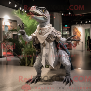 Mascot character of a Silver Velociraptor dressed with a Graphic Tee and Shawls