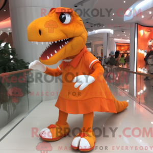 Mascot character of a Orange Tyrannosaurus dressed with a Skirt and Shoe clips