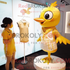 Mascot character of a Gold Pigeon dressed with a One-Piece Swimsuit and Hairpins