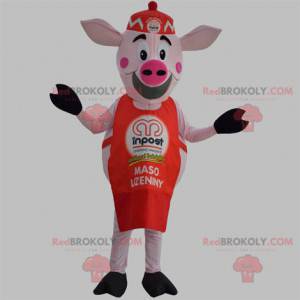 Mascotte de cochon rose avec un tablier rouge et un bonnet -