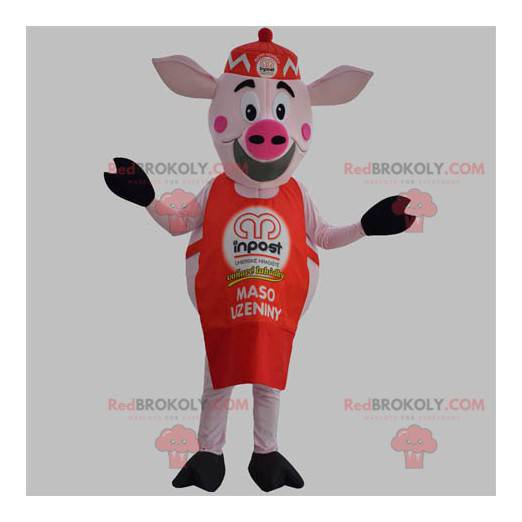 Mascotte de cochon rose avec un tablier rouge et un bonnet -