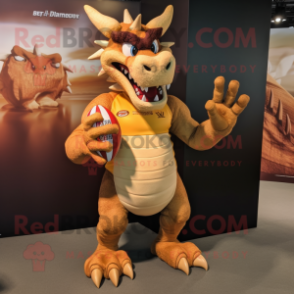 Tan Dragon mascot costume character dressed with a Rugby Shirt and Rings