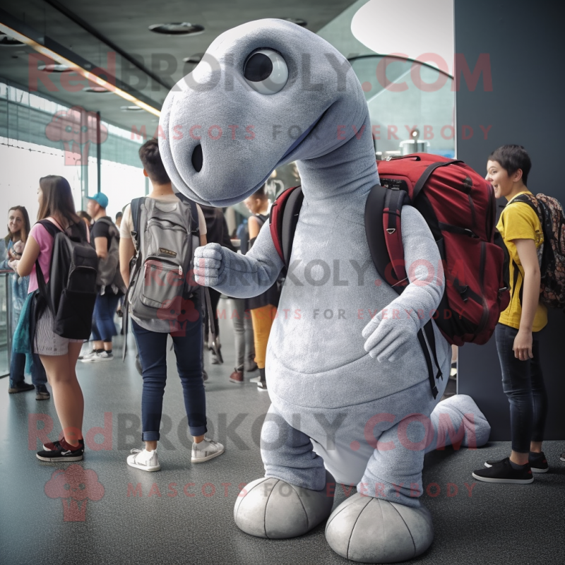 Silver Diplodocus mascot costume character dressed with a Skinny Jeans and Backpacks