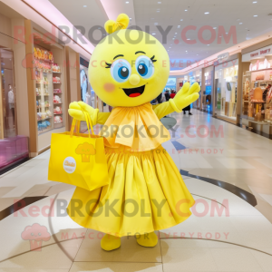 Yellow Candy Box mascot costume character dressed with a Ball Gown and Tote bags