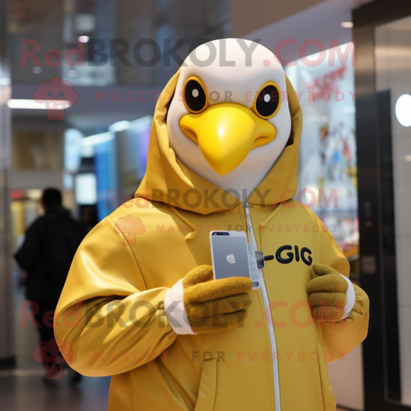 Gold Gull mascot costume character dressed with a Hoodie and Smartwatches