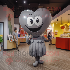 Gray Heart Shaped Balloons mascot costume character dressed with a Graphic Tee and Watches