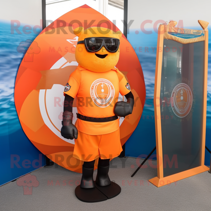 Orange Celtic Shield mascot costume character dressed with a Rash Guard and Sunglasses