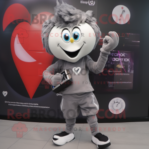 Gray Heart mascot costume character dressed with a T-Shirt and Digital watches