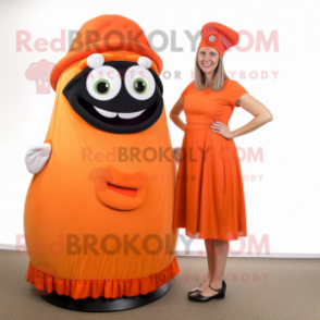 Orange Cyclops mascot costume character dressed with a Maxi Skirt and Berets