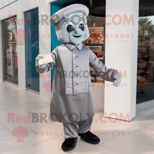 Silver Chocolate Bar mascot costume character dressed with a Dress Pants and Berets