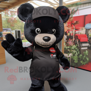 Black Teddy Bear mascot costume character dressed with a Graphic Tee and Headbands
