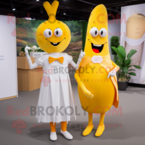 Yellow Carrot mascot costume character dressed with a Wedding Dress and Clutch bags