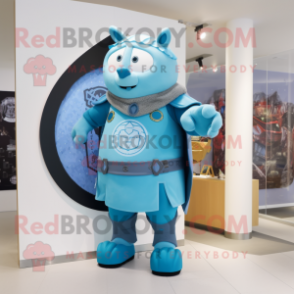 Sky Blue Celtic Shield mascot costume character dressed with a Dungarees and Mittens