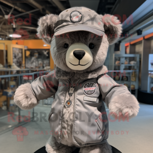 Gray Teddy Bear mascot costume character dressed with a Bomber Jacket and Hat pins