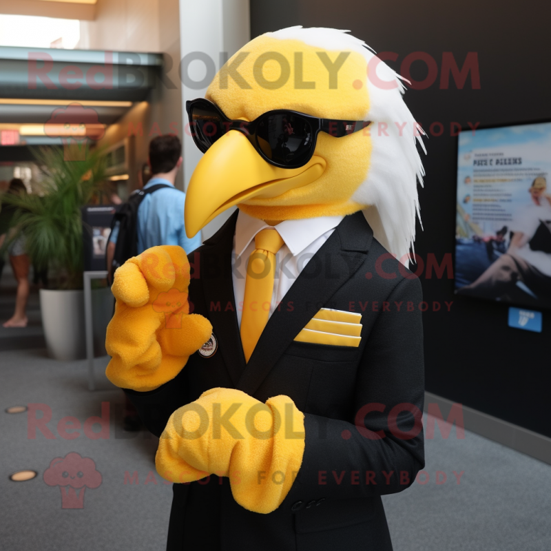 Yellow Bald Eagle mascot costume character dressed with a Suit Jacket and Eyeglasses