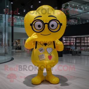 Yellow Heart Shaped Balloons mascot costume character dressed with a Romper and Reading glasses
