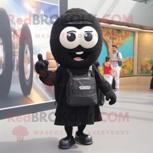 Black Falafel mascot costume character dressed with a Suit Pants and Backpacks