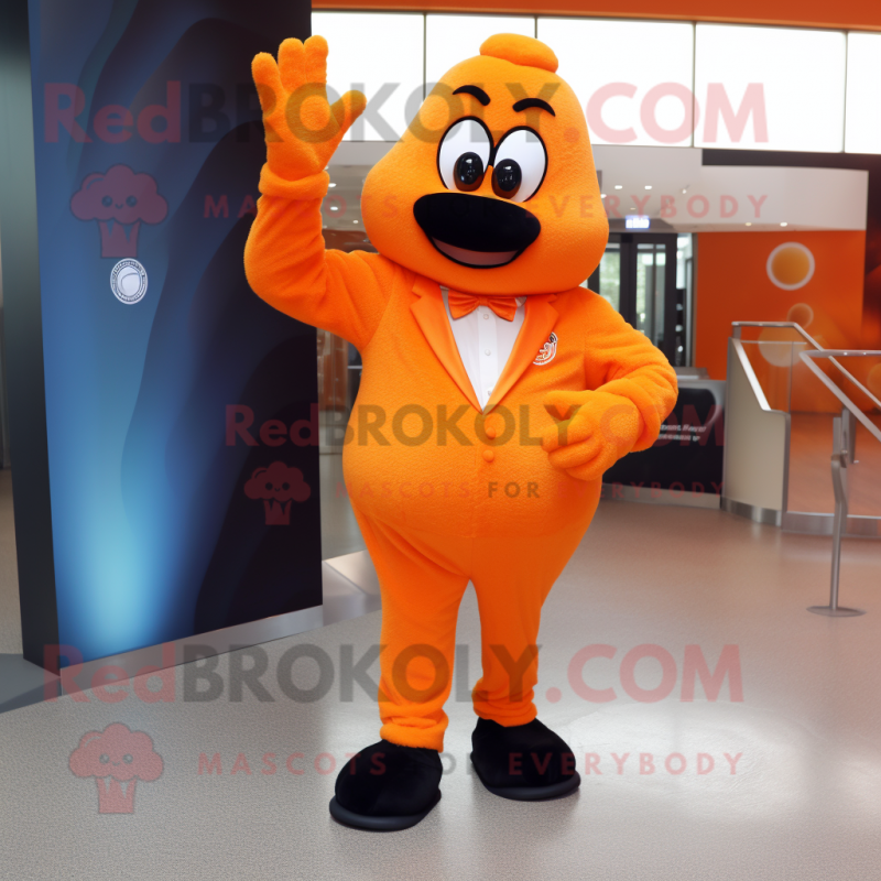 Orange Momentum mascot costume character dressed with a Suit Pants and Gloves